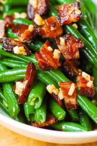 Garlic and Bacon Green Beans sautéed in olive oil and butter in a large skillet on stove top