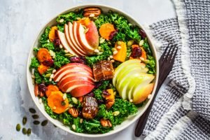 Winter salad with apple pumpkin cranberries honey seeds